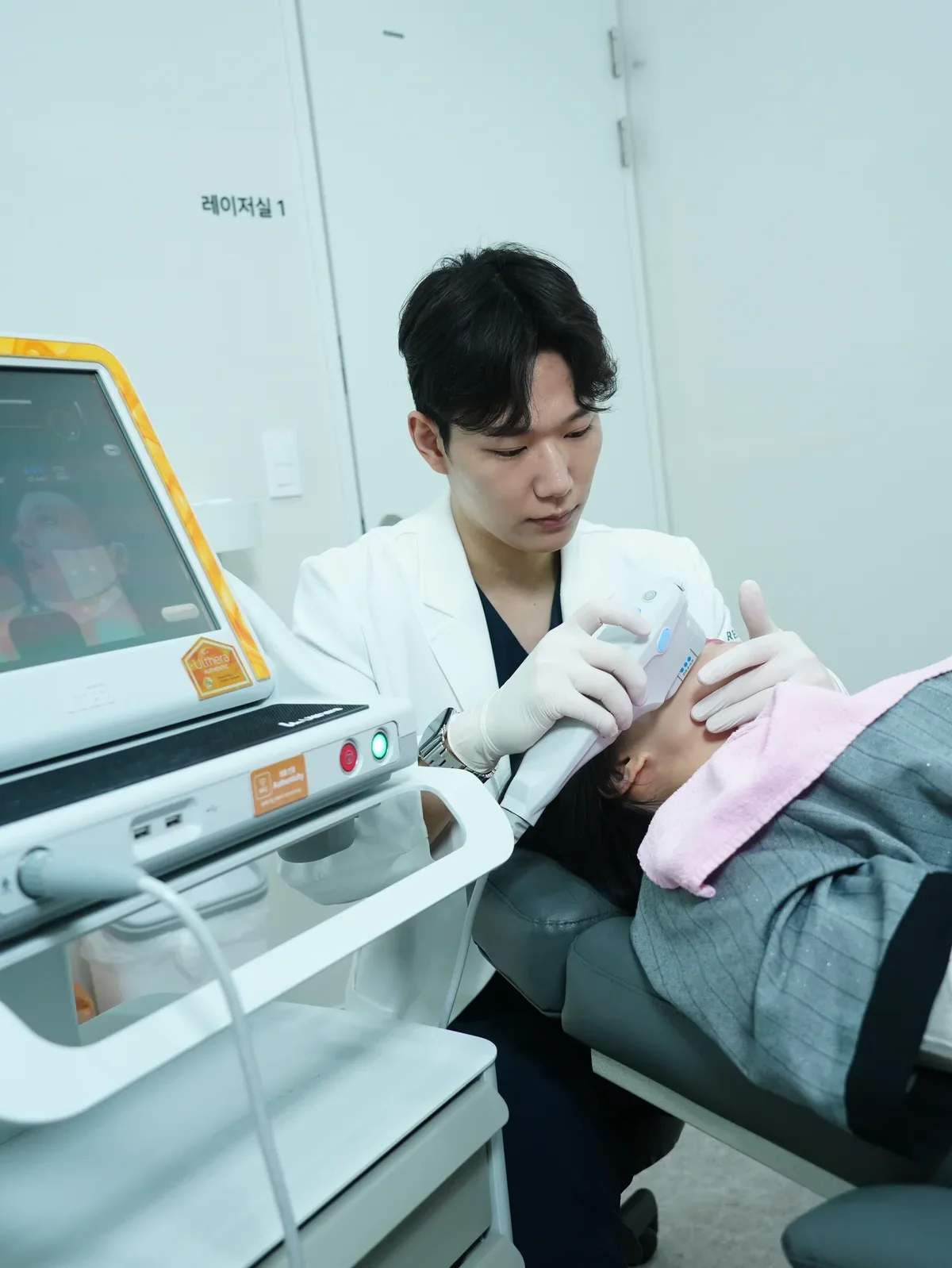Ultherapy Prime HIFU treatment setup — doctor using focused ultrasound handpiece with real-time ultrasound imaging at RE:BERRY Clinic Gangnam